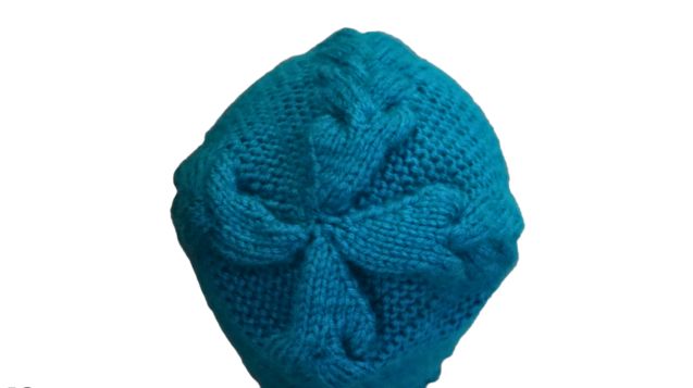 Top View of a Hand-Knitted Chunky Cable Beanie in Blue Color.