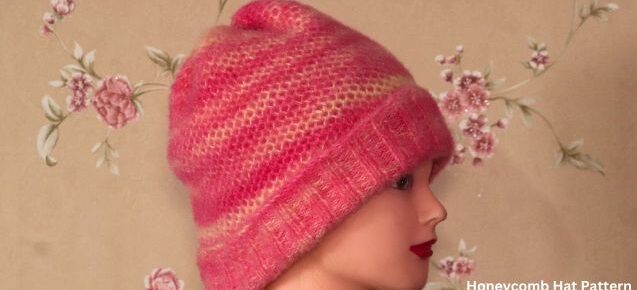 A doll wears a hand-knitted honeycomb hat using multicolor 3-ply wool.