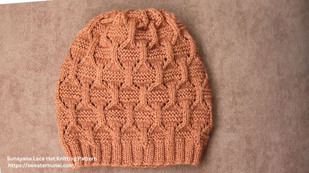 Vibrant brown knitted hat featuring a cozy, stylish lace knitting pattern, perfect for keeping warm in cold weather.